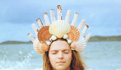 Image of Malin Lewis wearing a shell crown