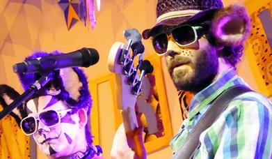 Image of singers on stage dressed up as animals