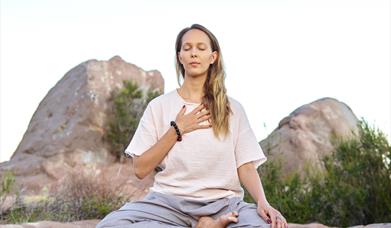 A person meditating in nature