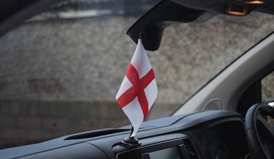 Image of an England flag inside a car