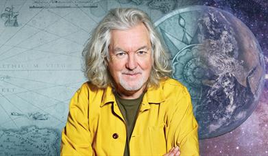 James May with maps and the universe behind him