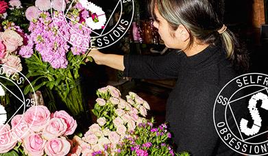 A woman next to flowers